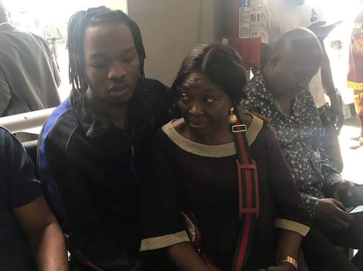 EFCC tenders evidence found on Naira Marley's laptop, iPhone in court + Photos of the Singer with his mother in court