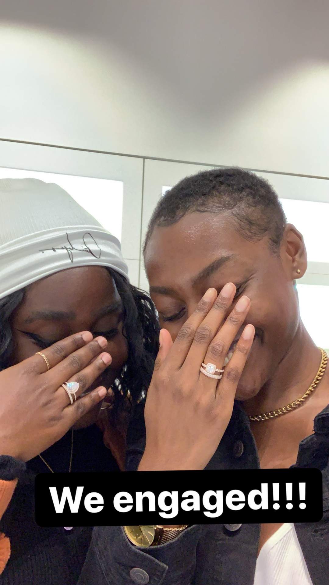 Two ladies show off their rings to announce their engagement to each other