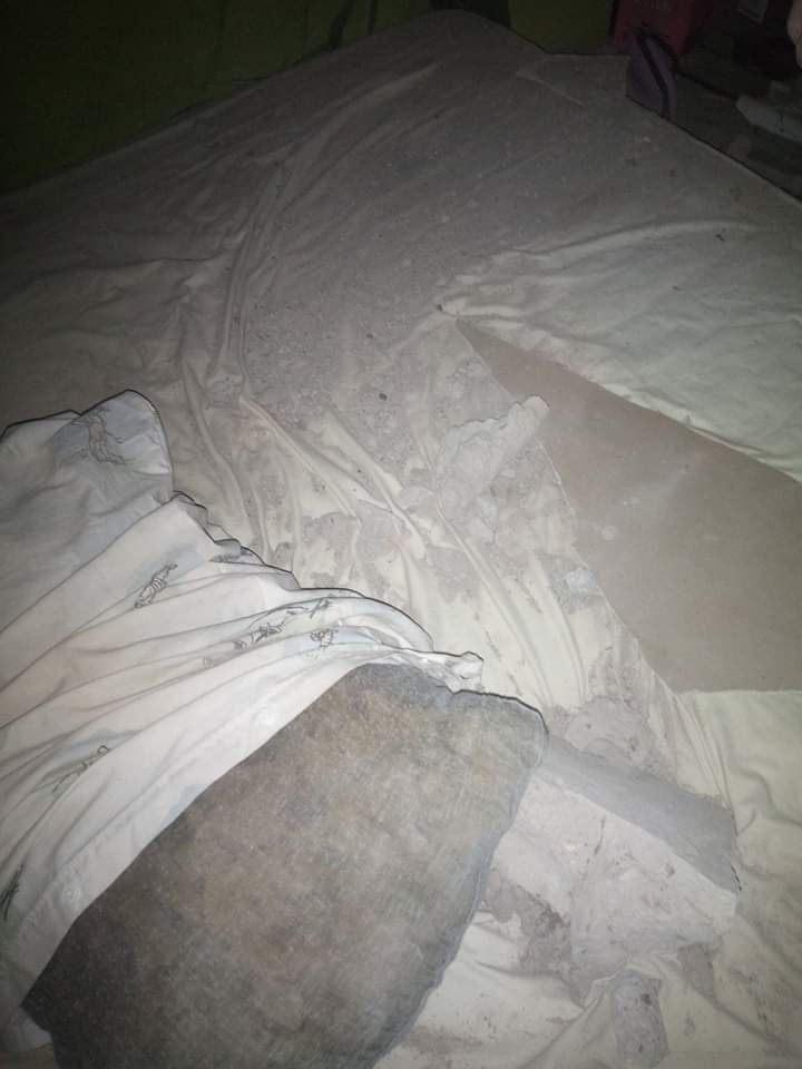 Woman and her baby narrowly escapes death after huge block crashes through roof, bedroom ceiling, and fell on them while sleeping (photos)