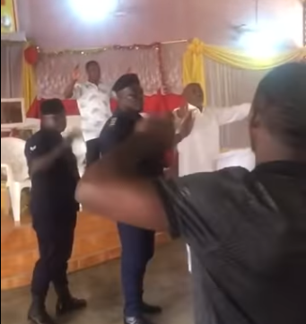 Moment police storm packed church to arrest the pastor for conducting service despite government order banning public gatherings (video)