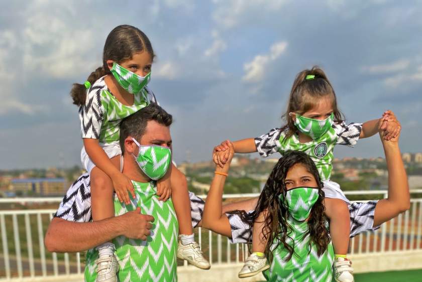 White Nigerian shares an adorable family photo with Nigeria's jersey & face mask