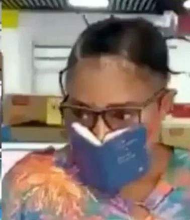 Woman seen using a mini Bible as a face mask against the novel coronavirus (video)