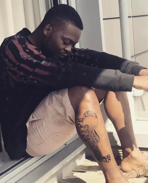 What do Olamide's tattoos mean?