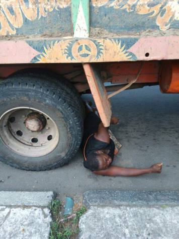 Photos: Nigerian Lady begs Trailer Driver To Crush Her After Her Goods Were Seized In Calabar, Rivers State