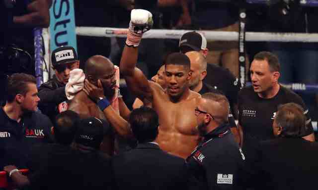 Anthony Joshua beats Carlos Takam by TKO to retain world heavyweight titles.