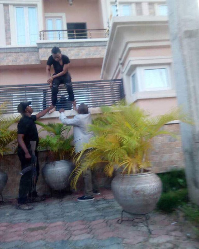 Picture of Bobrisky being thrown over the gate by police after he was arrested last month