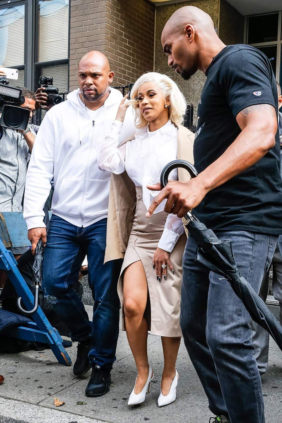 Cardi B pictured all smiles as she leaves police precinct after turning herself in
