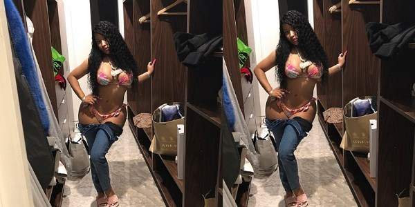 Nicki Minaj takes down her jeans to reveal her skimpy underwear in new photo.