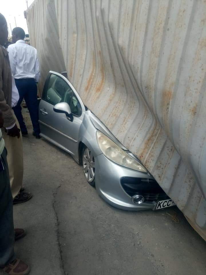 Container falls on woman's car moments after she stepped out with her baby. (photos)