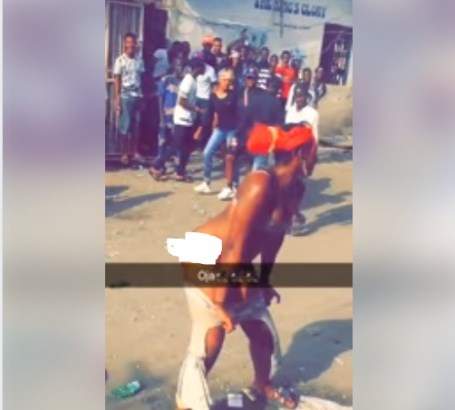 Lady strips off in the middle of a road in Lagos (photos)