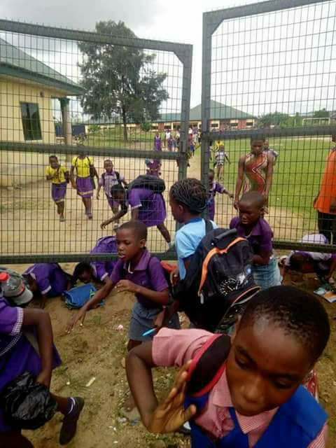 See Photos Of Children Jumping Over School Fence To Escape Vaccination By Soldiers In Rivers State.