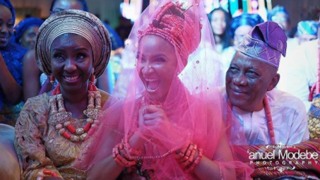 Adesua Etomi and Her Parents during her traditional wedding.