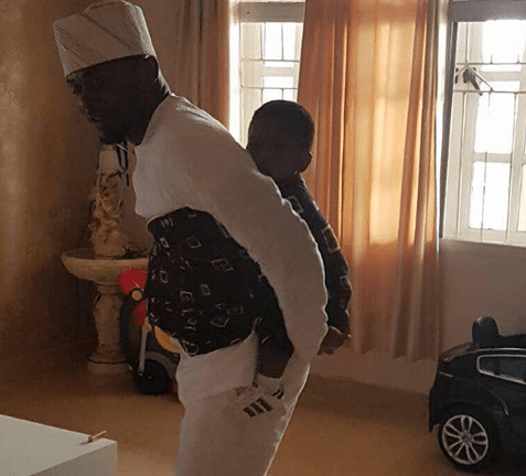 'Fire Burn You' - Ubi Franklin Replies Follower Who Faulted Photo Of His Son Strapped To His Back