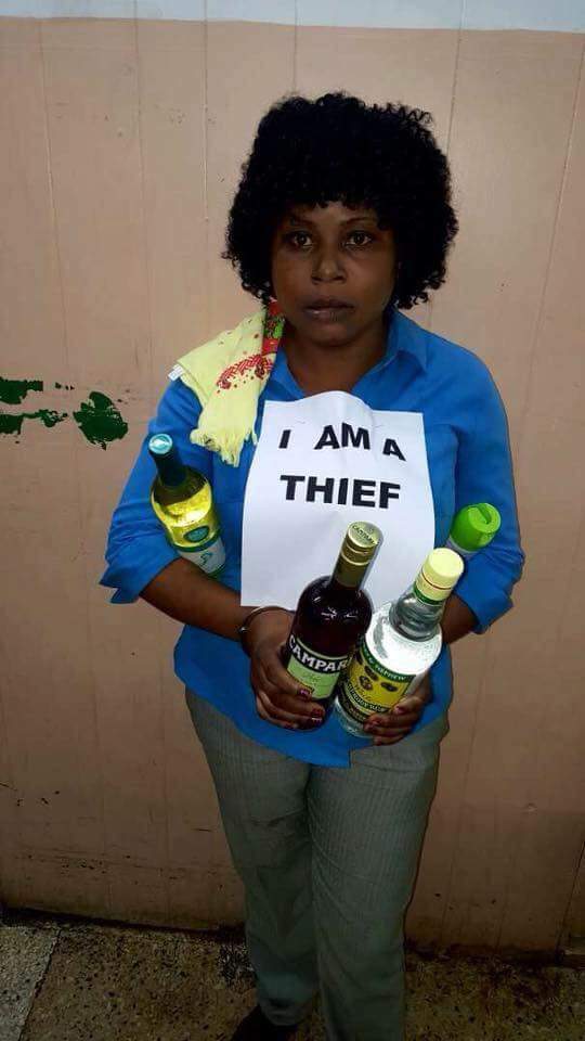 Lady wears "I Am A Thief" Tag For Stealing Wines At A Shopping Mall. (Photo)