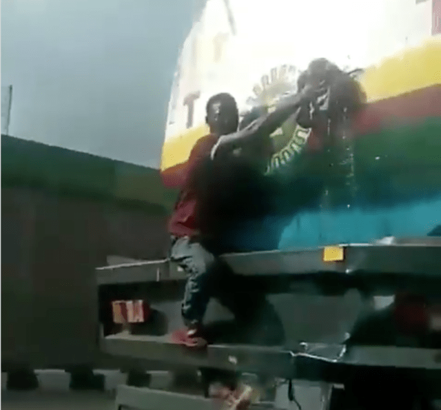 NNPC fuel tanker seen leaking seriously on the road in Lagos as young boy tries to block it. (Video)