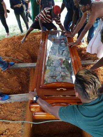 Man buries his father with N2.8m in cash, filled inside his glass coffin