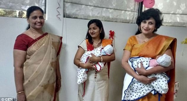Grieving mum Prathamesh Patil, 49, (left) alongside her doctor (right) in orange gown with the New Born Twin Babies Photo Credit - CEN