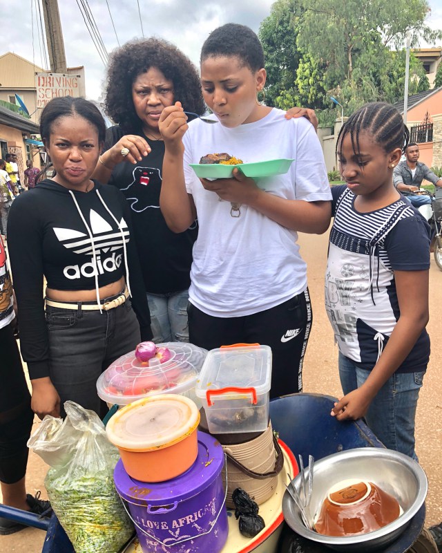 Regina Daniels pictured eating Abacha by the roadside (photos)