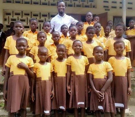 Young Ghanaian teacher sews school uniforms for pupils with his monthly salary