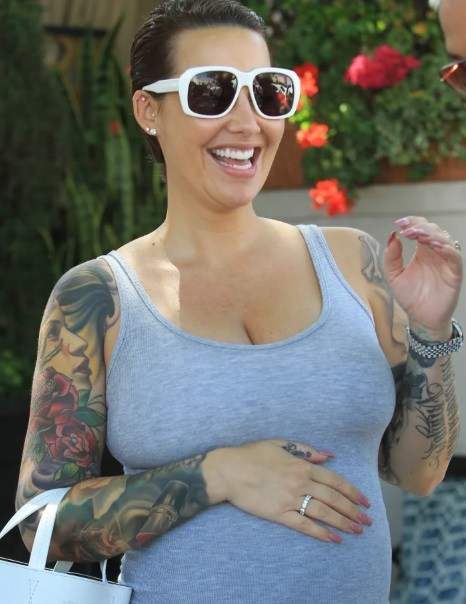 Amber Rose dumps her signature blonde look as she starts growing her hair (Photos)