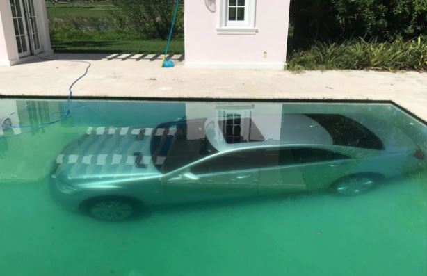 Banker's Dumped Girlfriend Drives His Mercedes Car Into A Swimming Pool As Revenge. (Photos)