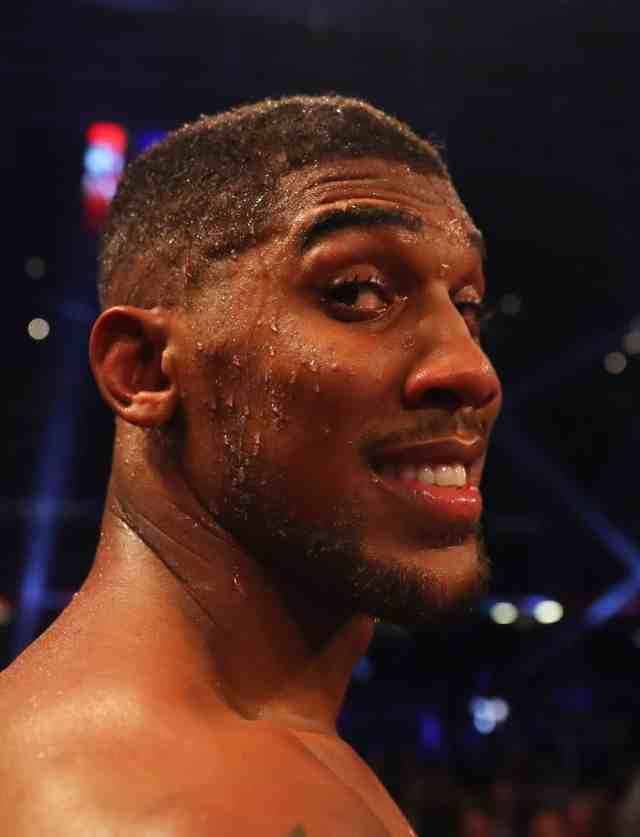 Anthony Joshua beats Carlos Takam by TKO to retain world heavyweight titles.