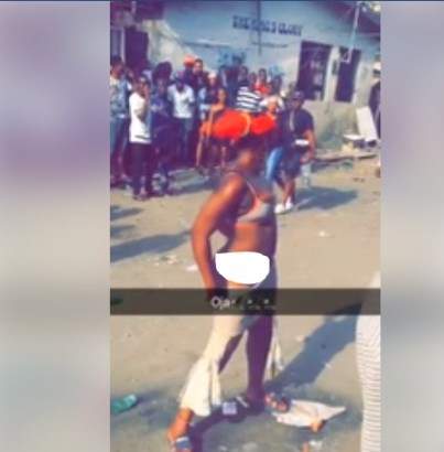 Lady strips off in the middle of a road in Lagos (photos)