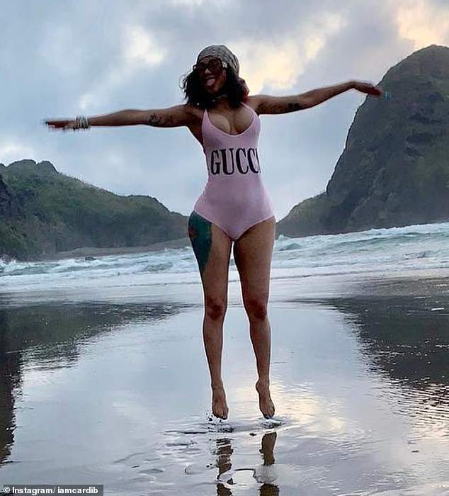 Cardi B shows off her cleavage and nips in revealing swimsuit (Photos)
