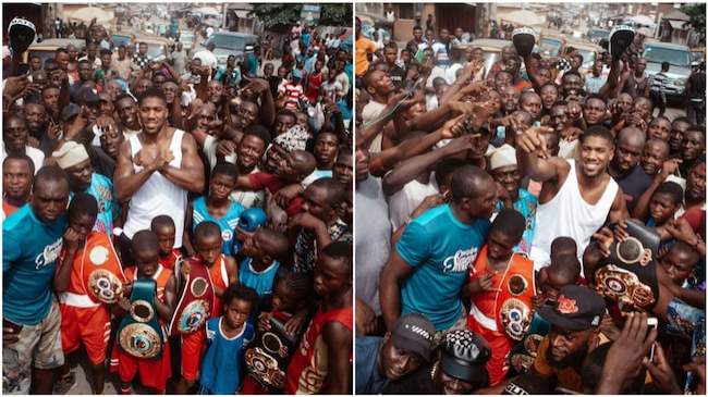 Anthony Joshua storms popular Lagos slum, allows 4 children take his belts from him (photos)
