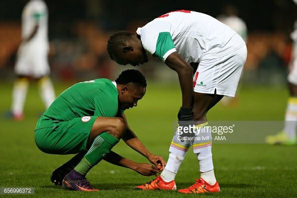 Ahmed Musa Pictured Tieing The Boots Of A Senegalese Player (Photo)