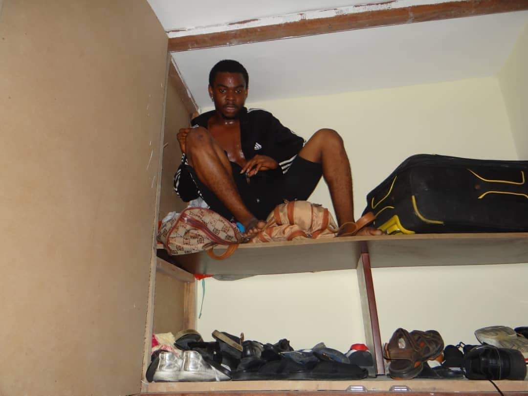Suspected Yahoo Boy Hides Inside Cupboard During EFCC Raid (Photos)