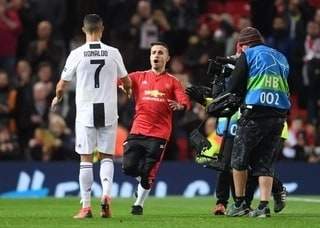 Checkout what Ronaldo did to a pitch invader who tried to mob him at Old Trafford (photos)