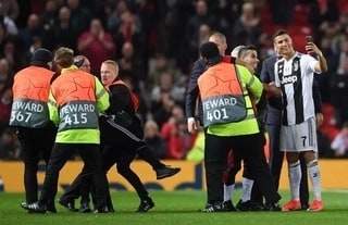 Checkout what Ronaldo did to a pitch invader who tried to mob him at Old Trafford (photos)