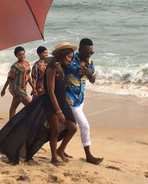 Adekunle Gold, pictured with his arms around Simi's shoulder. (Press)