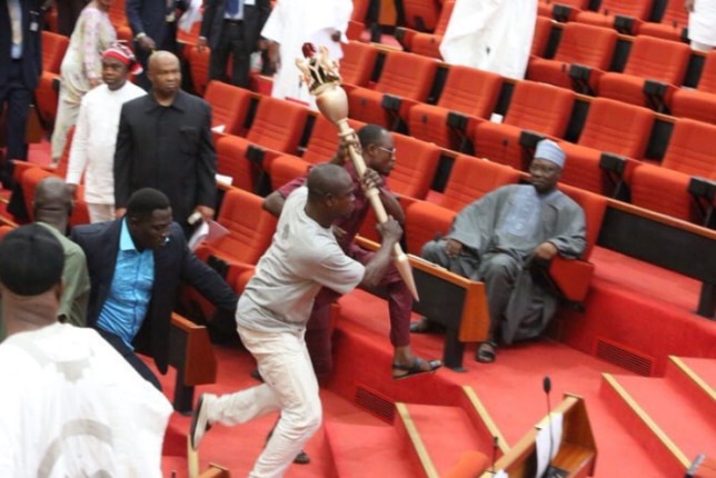 Hoodlums associated with Senator Ovie Omo-Agege run out of the upper legislative chamber of the National Assembly with the mace (Twitter/@PRINCE_VIIII)